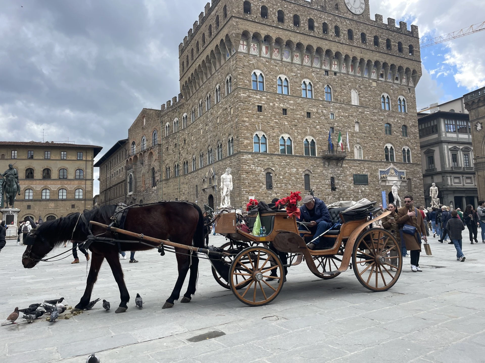 a horse pulling a carriage with people in it