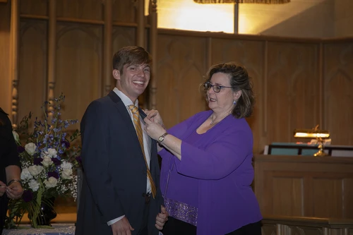 Dr. Janice Williams, program director, gives senior nursing major Rafe Dillard his nursing pin. 