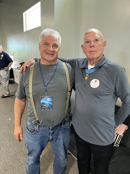 Two men posing for photo.