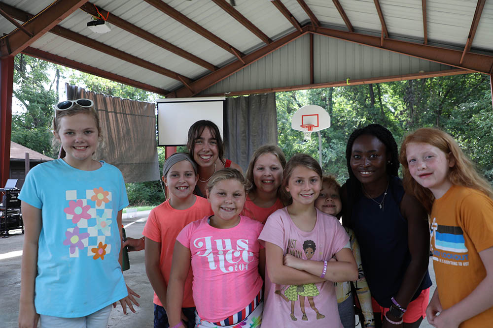 Children with student counselors at camp