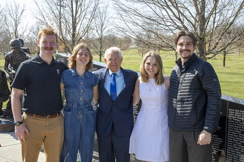 Dan Bunch standing with students