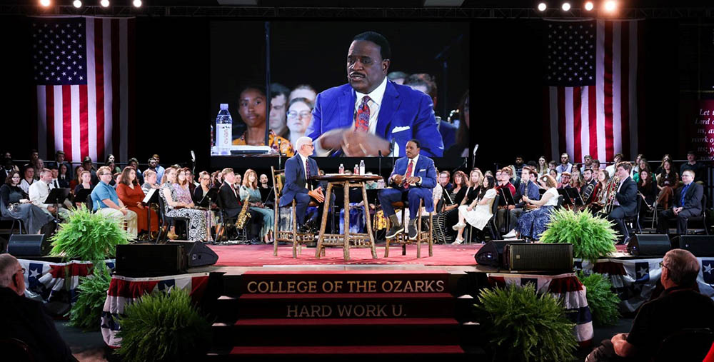 Dr. Brad Dolloff, dean of School of the Ozarks, and James Brown “JB”, host of The NFL Today on CBS, give remarks on stage at the College of the Ozarks Fall Convocation. The convocation followed a fireside chat style, hosted by Dolloff. Student athletes joined them on stage as JB answered questions about living a life of faithful influence.