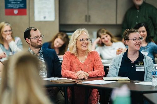 People smiling in conference room