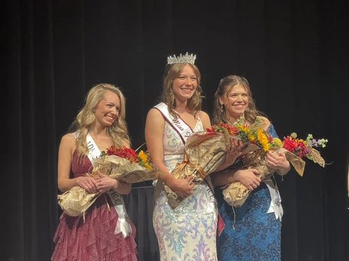 Three girls standing with flowers