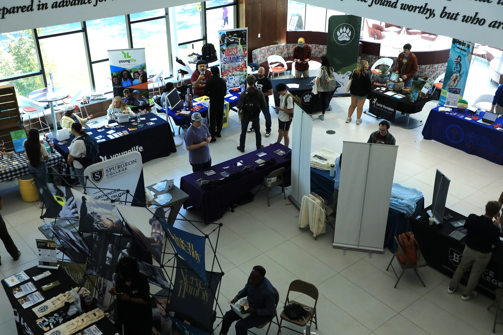 This image depicts a ministry fair. There are tables and people everywhere. 