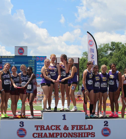 Team standing on podium.