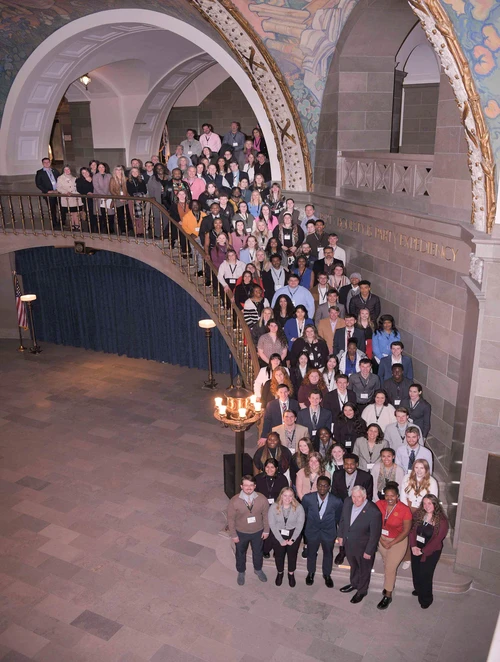 Students lined up in the staircase in the Capitol Building with Governor Mike Parson.