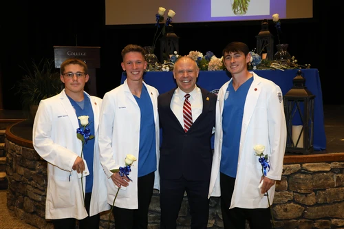 Students standing with College President.