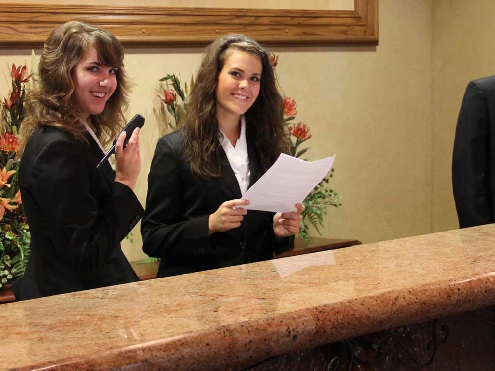 Student at hotel registration desk