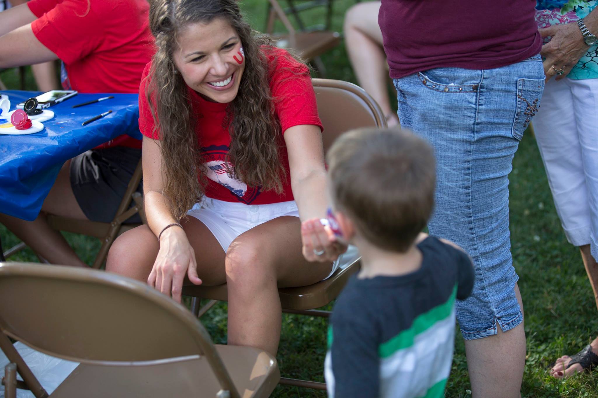 A camper getting his face painted.
