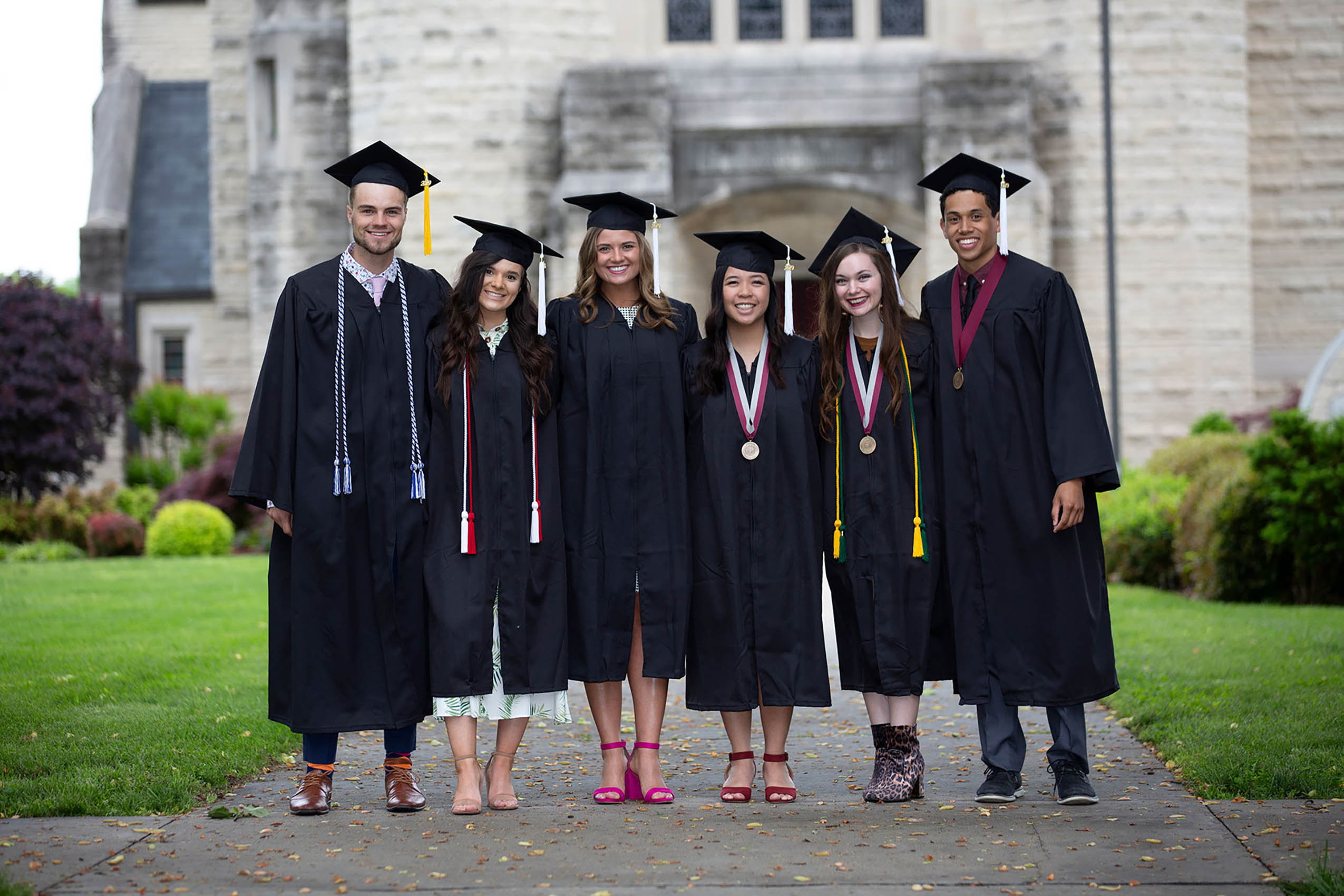 Several Students Standing in front of the chapel after graduating