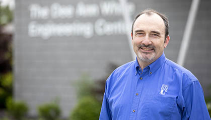 Professor in front of Engineering Center