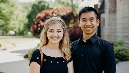 Two students standing infront of the chapel