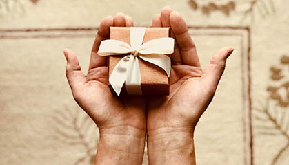 Two hands holding a giftbox. 