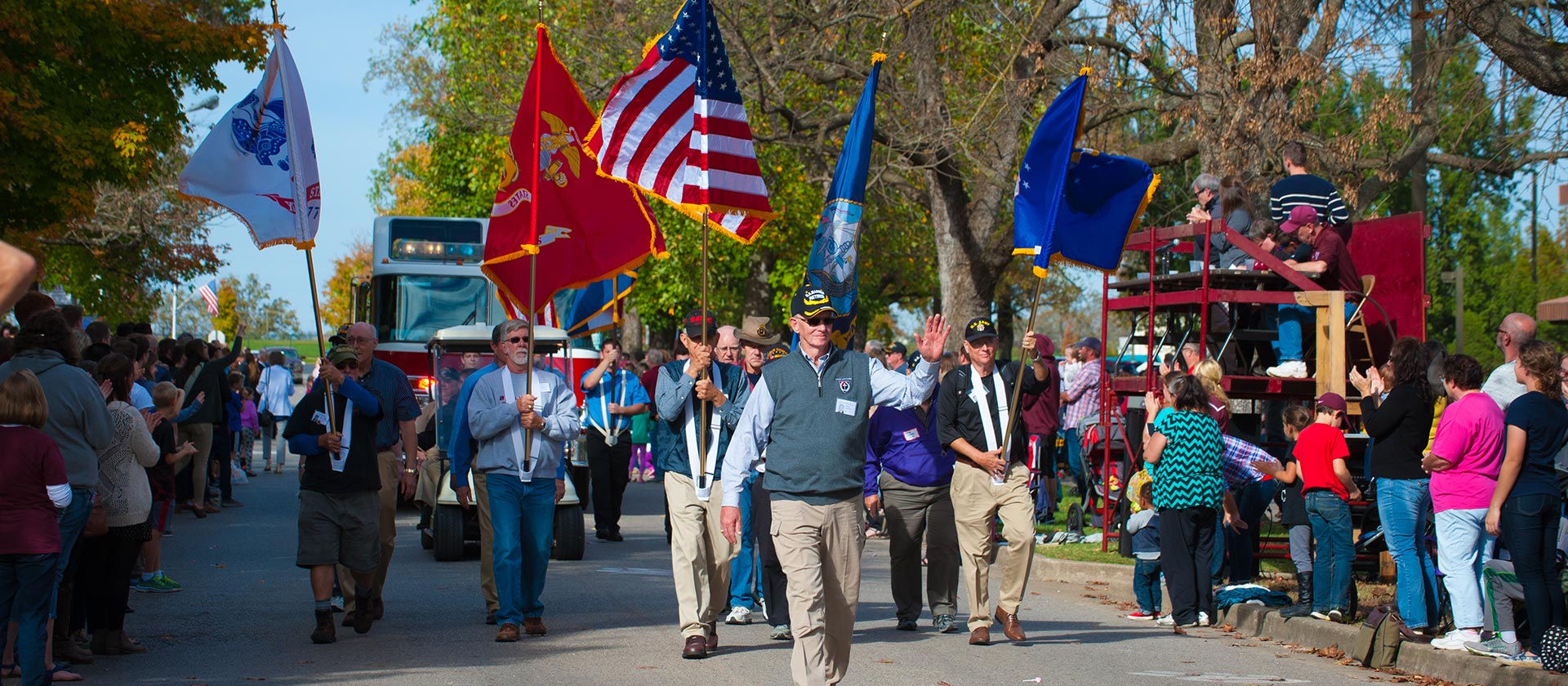 Alumni walking in homecoming parade. 