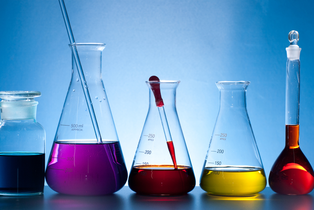 Beakers with various colored chemicals inside