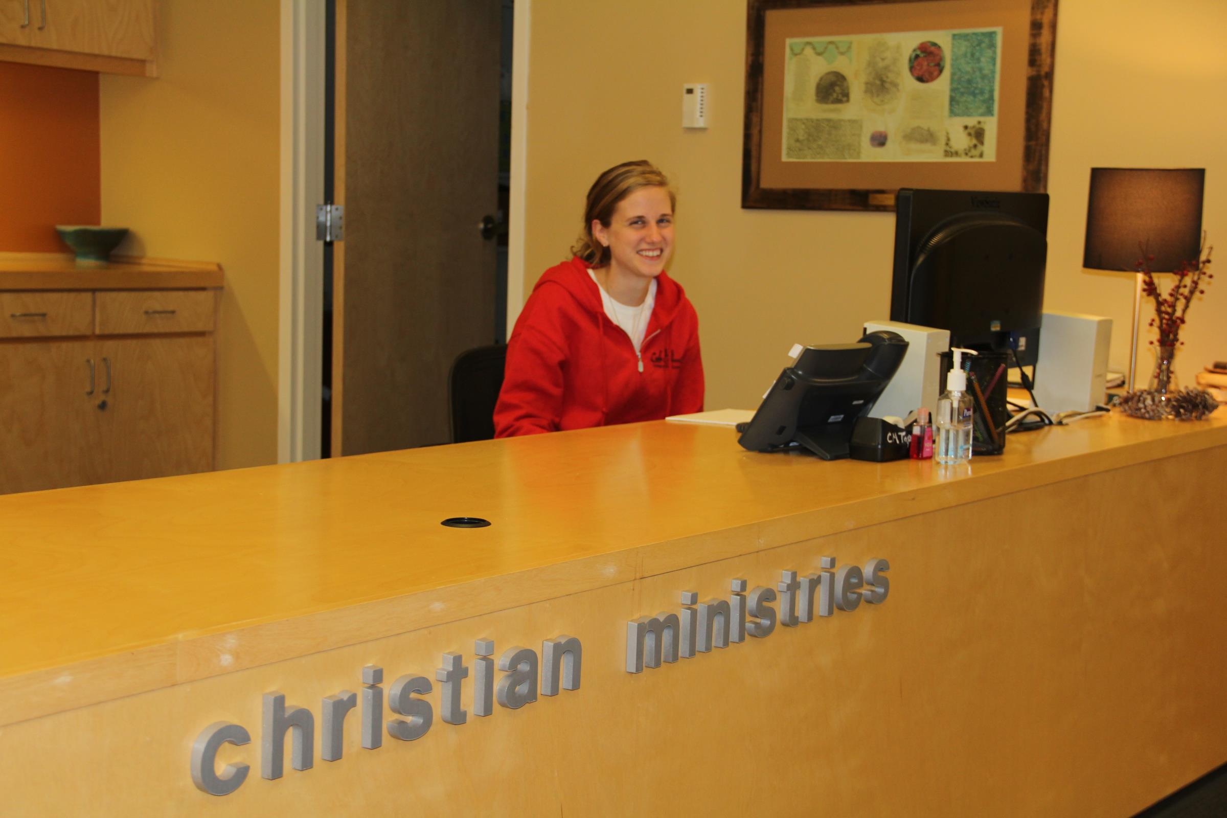 Student sitting behind the desk at Christian Ministries