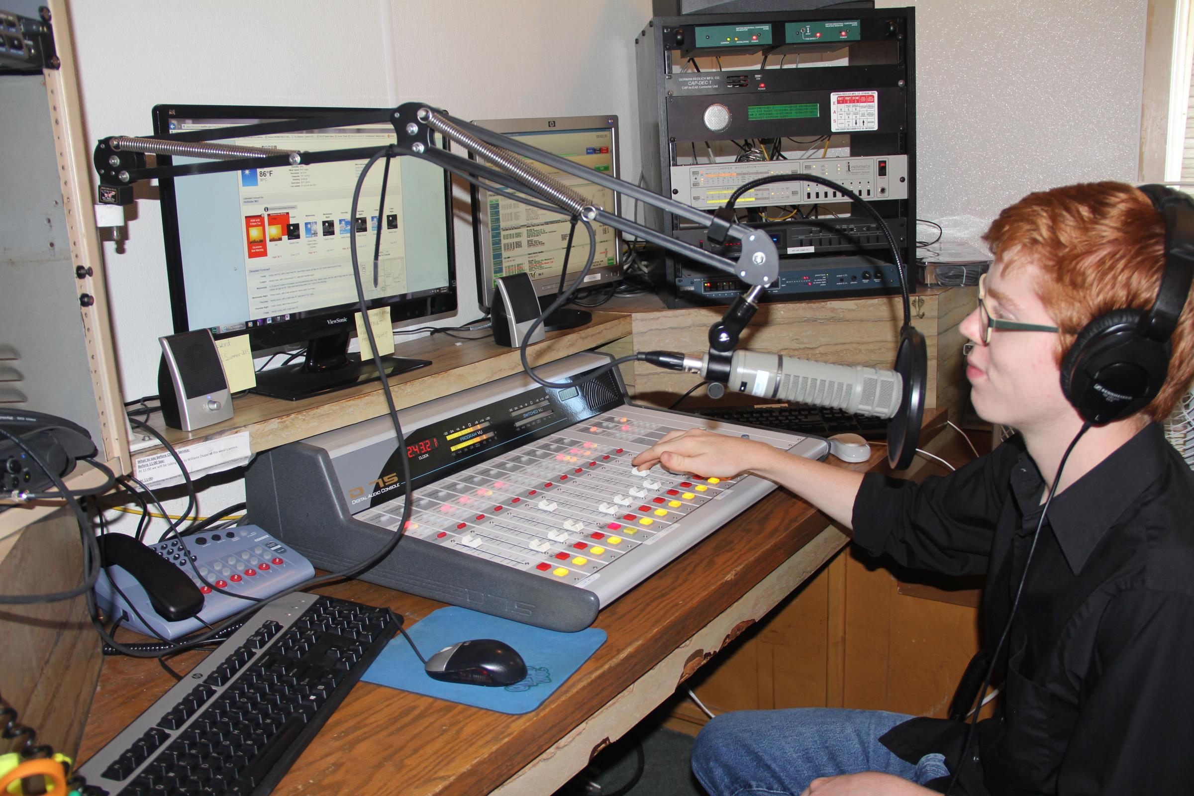 Student operating the radio station equipment