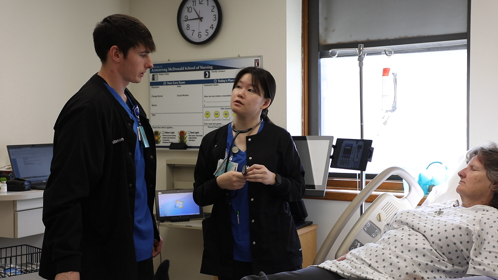 Students working with a learning dummy