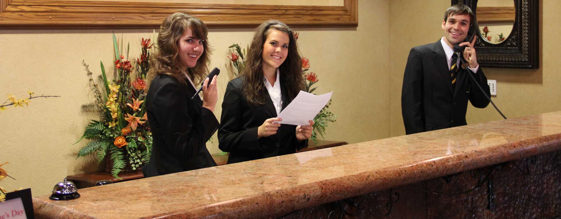 3 students working the front desk
