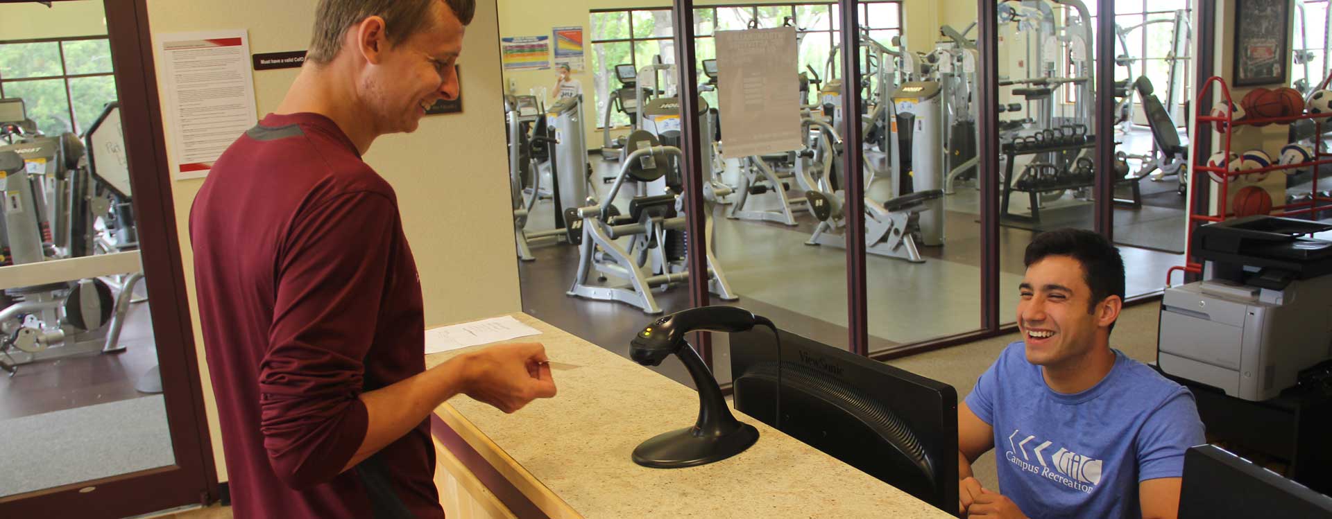 A student inquiring information outside the campus gym