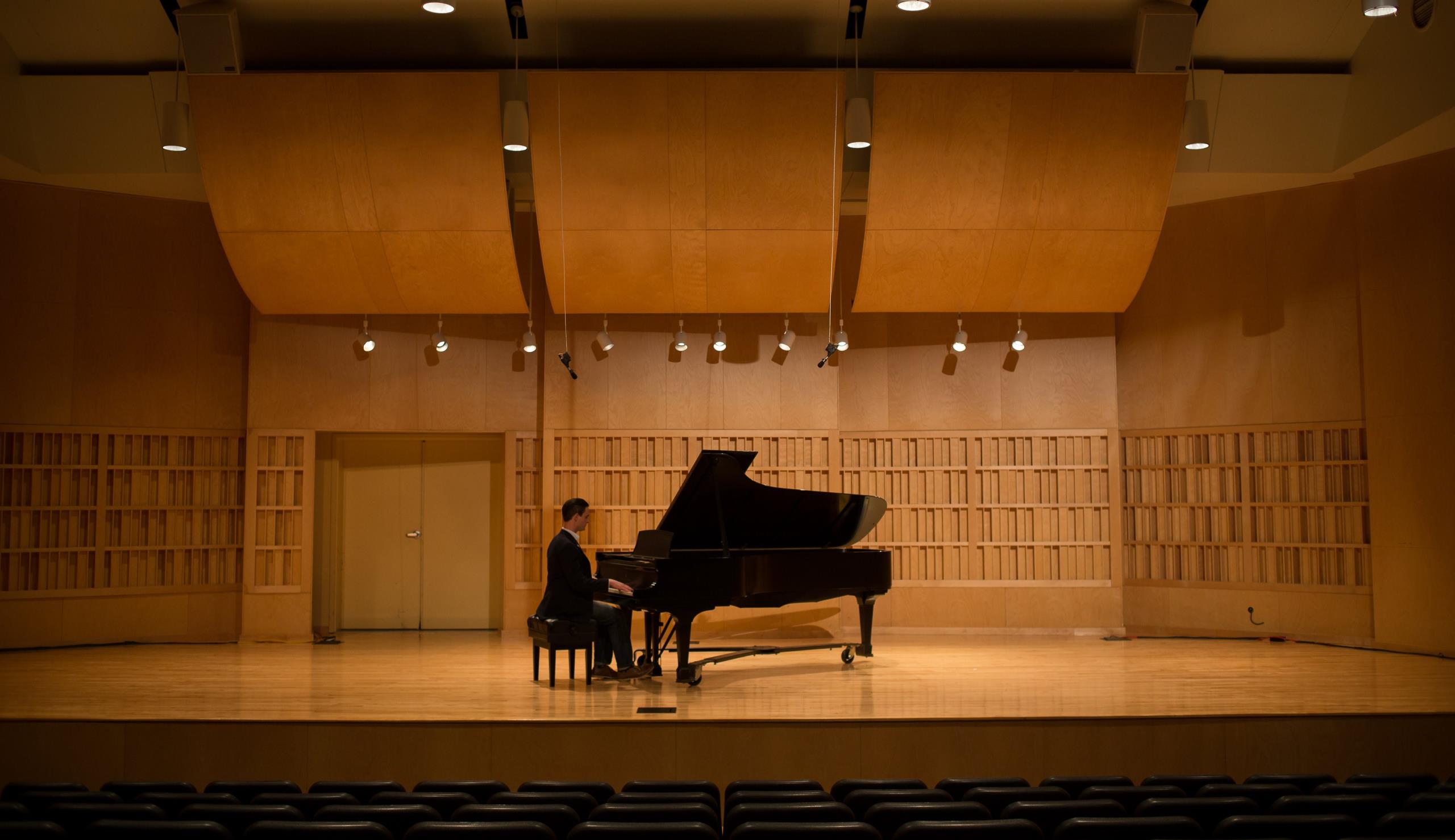 Student performing on a piano