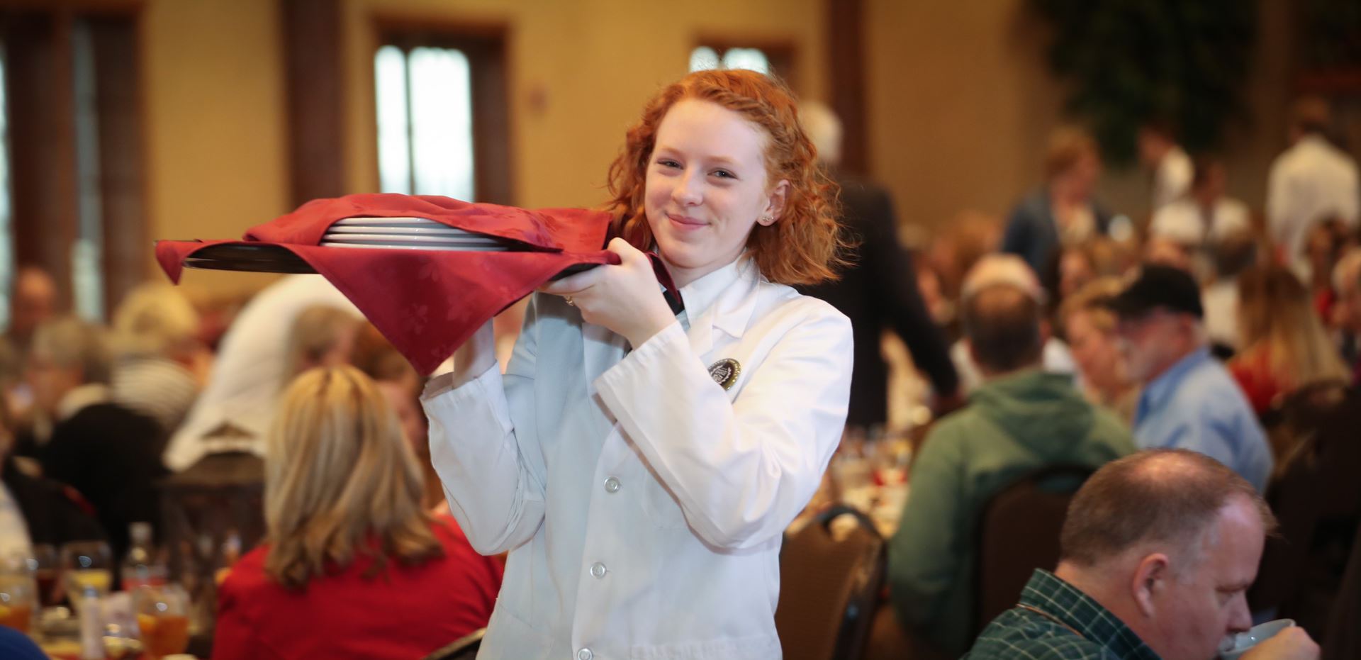 Student carrying plates