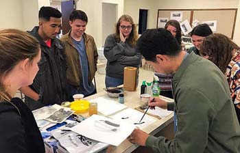 Artist Delro Rosco with students observing