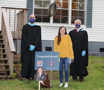 Senior Kara Bergeron celebrates with greetings by school administrators – (L) Scott McElvain, assistant to the dean, and (R) Brad Dolloff, dean of School of the Ozarks.