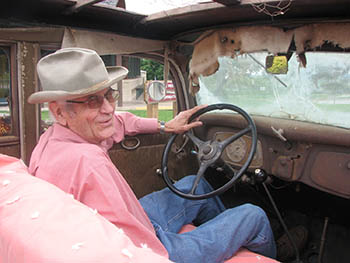 Dr. Howell W. Keeter inside the well worn cab of a truck.