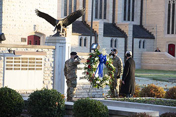 Alumni Veterans Memorial with ceremonial wreath. (L-R) Justice Knox, President Jerry C. Davis, Jackson Jones (Photo by Shann Swift)
