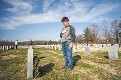 School of the Ozarks student Rhett Williamson, son of Angela Williamson, director of alumni affairs at the College, helps lay wreaths in Springfield National Cemetery. 