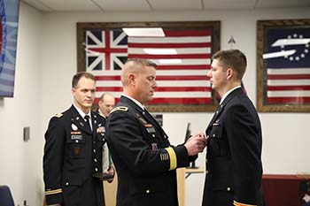 Brigadier General James Schreffler, associate professor of military science at College of the Ozarks and assistant adjutant general, Army, for the Missouri National Guard, presents 2nd Lt. Seth Ratliff with commission pin.