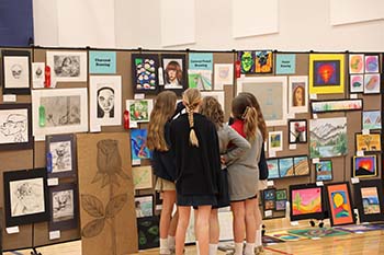 Students from area schools observe junior high art pieces in the annual Mark Twain Conference Art Show held at the Hook Activities Center on March 24.