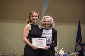 Bonnie Todd, associate professor of nursing, presents Casey Miller, class of 2021, with a program mission award at last year’s Pinning and Blessing Ceremony. 