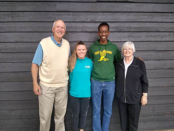 Al and Marty Waller present Mucyo Bangerezako and Hannah Aherin, 2022 C of O graduates, with the Chris Waller Memorial Scholarship to further their education.