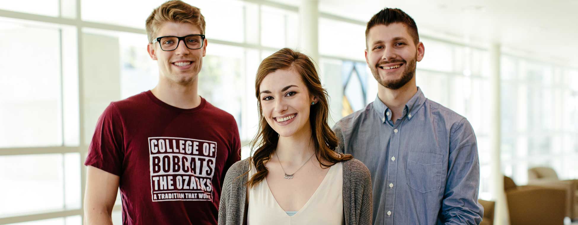 3 students smiling at the camera