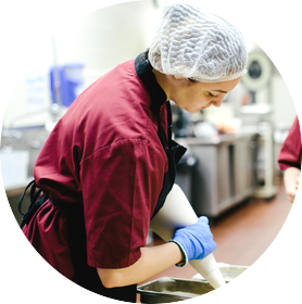 Student piping batter in the Fruitcake and Jelly Kitchen.